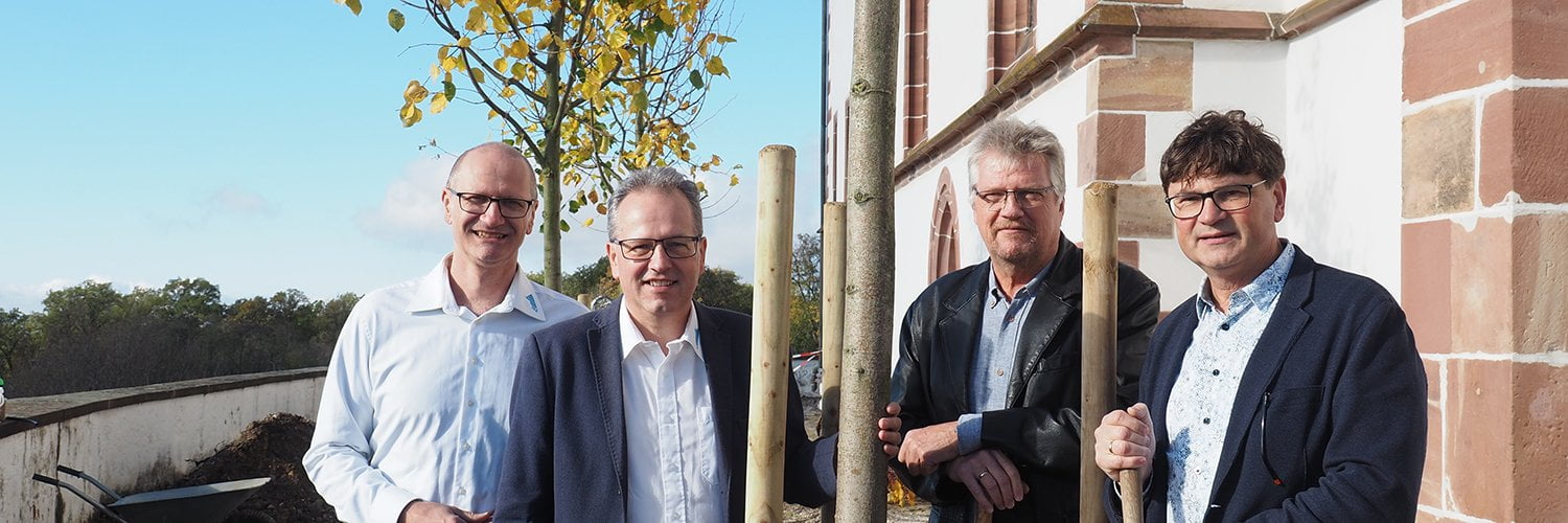 Die Vertreter von CGW (rechts vom Baum) und tsc (links vom Baum) freuen sich über die Pflanzung der CGW-Linde.